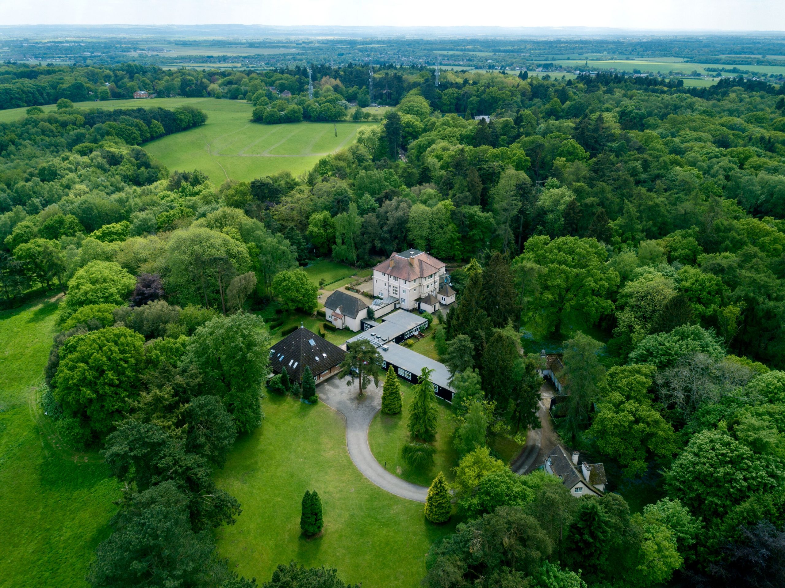 Aerial view of the Carmelite Priory at Boars Hill, surrounded by woodland
