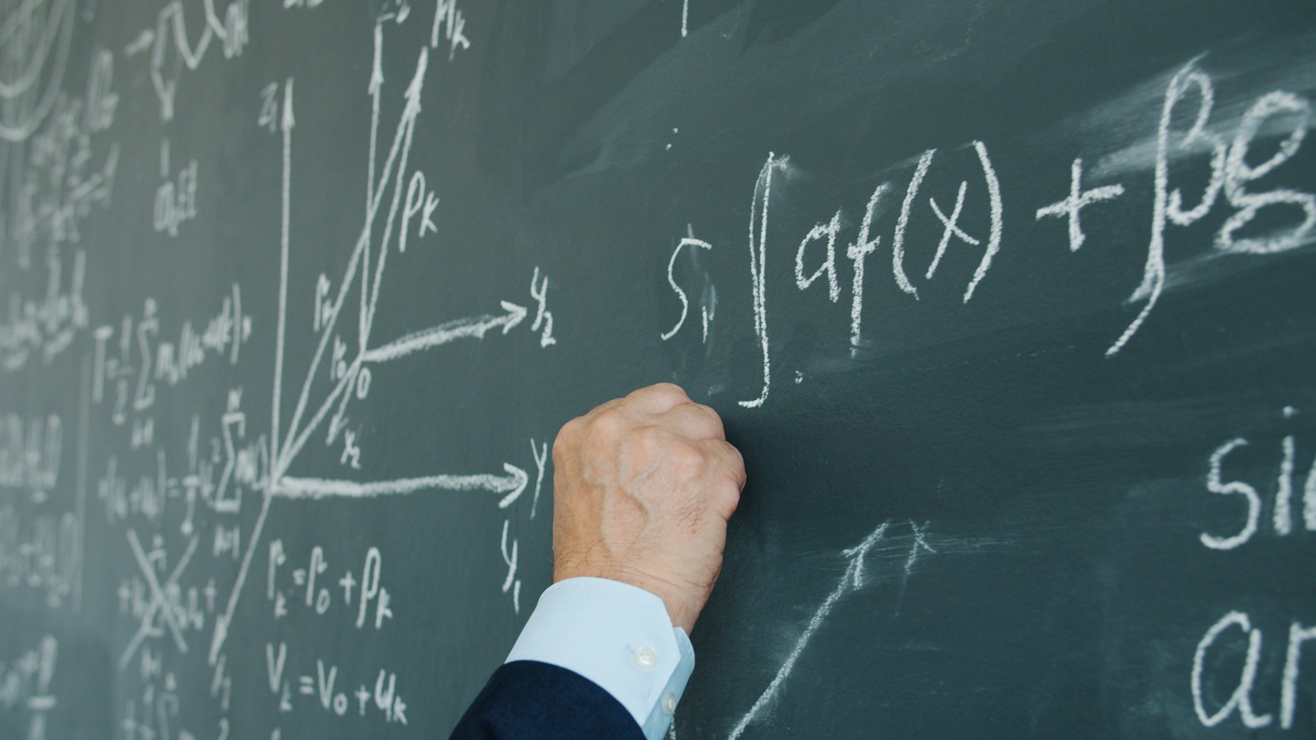 A teacher working with pupils in a classroom